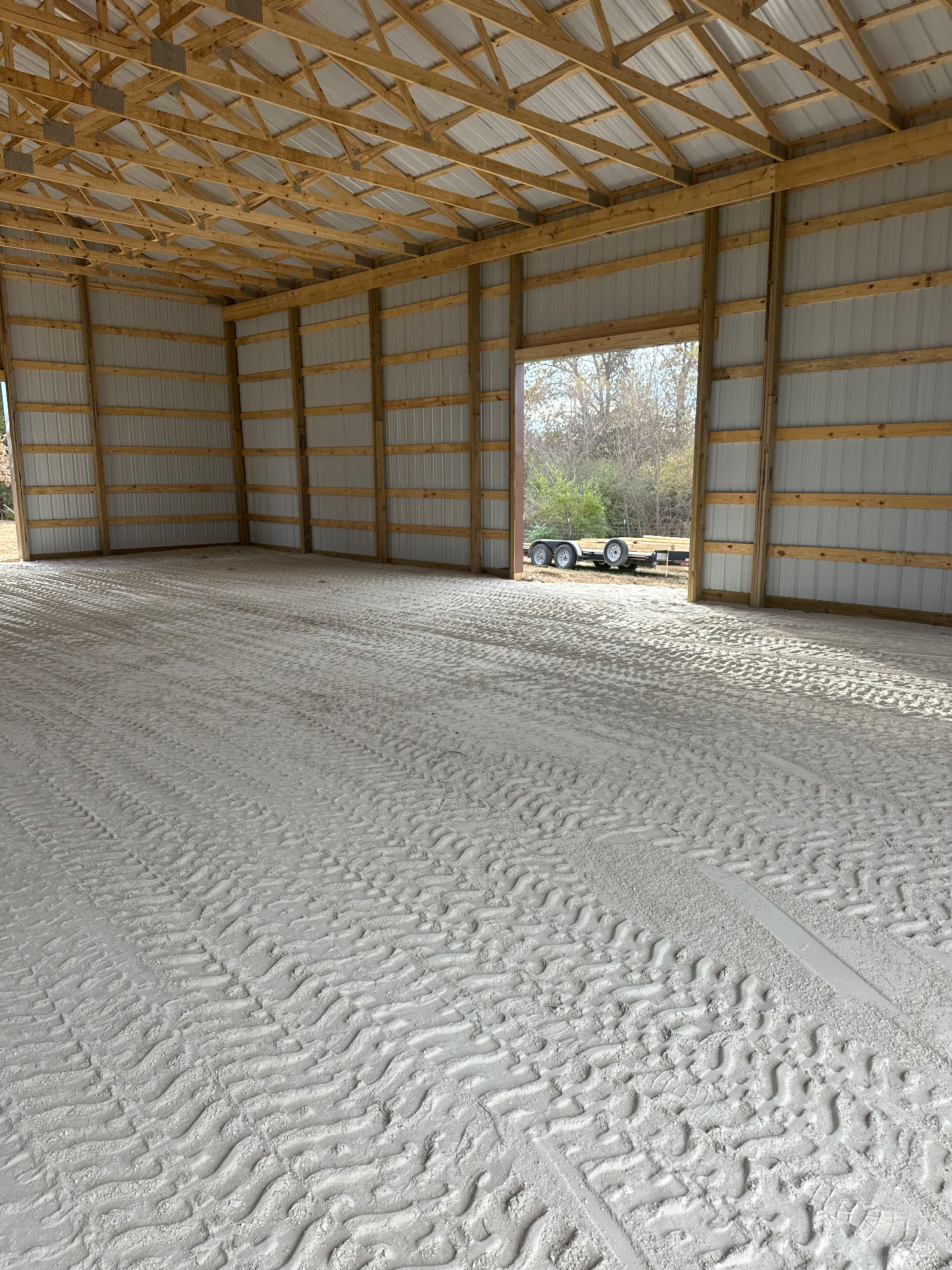 Completed building pad with compacted rock backfill tight against the foundation