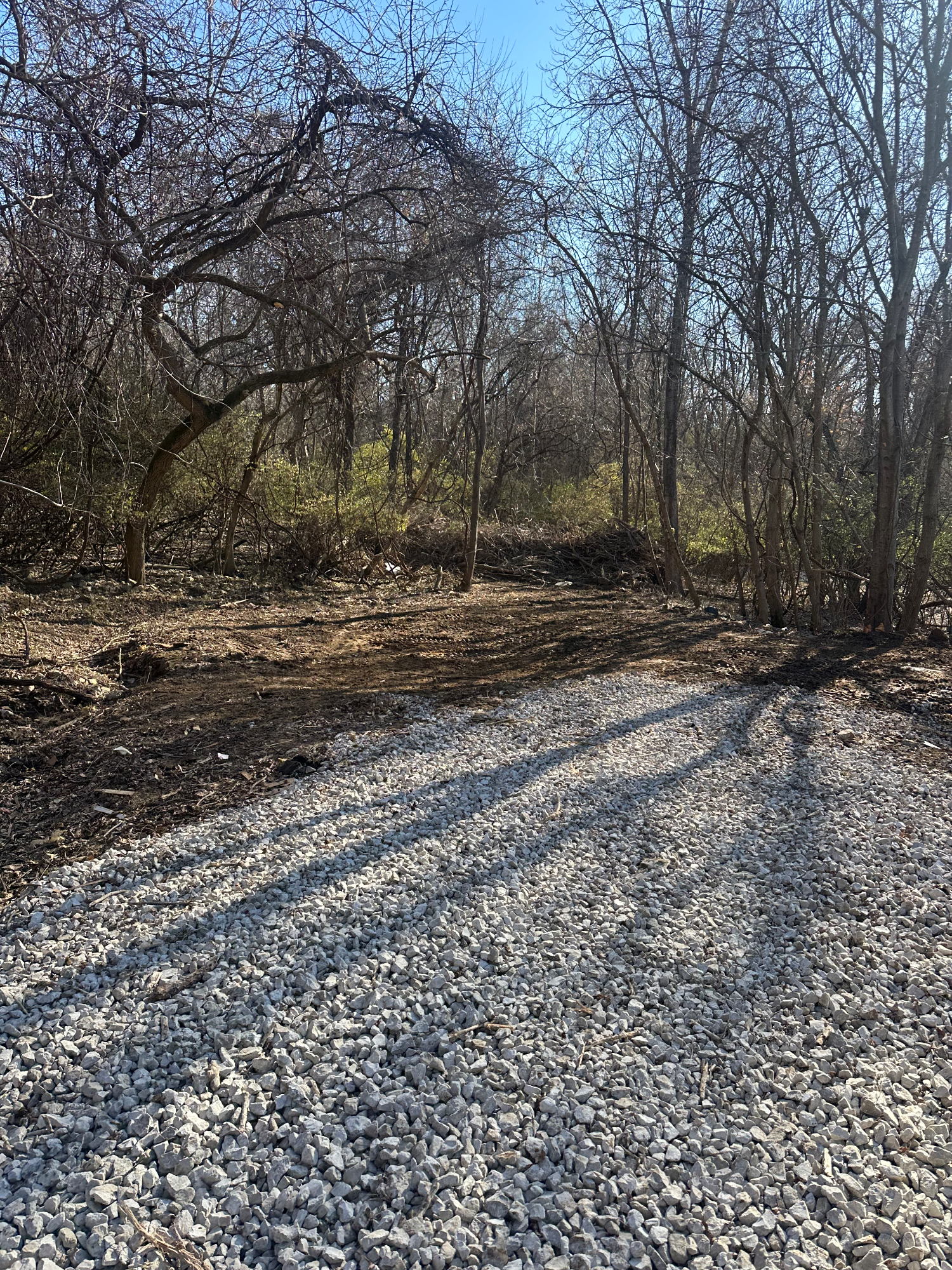 Same property cleared of the camper and all debris, leaving a clean open lot ready for use