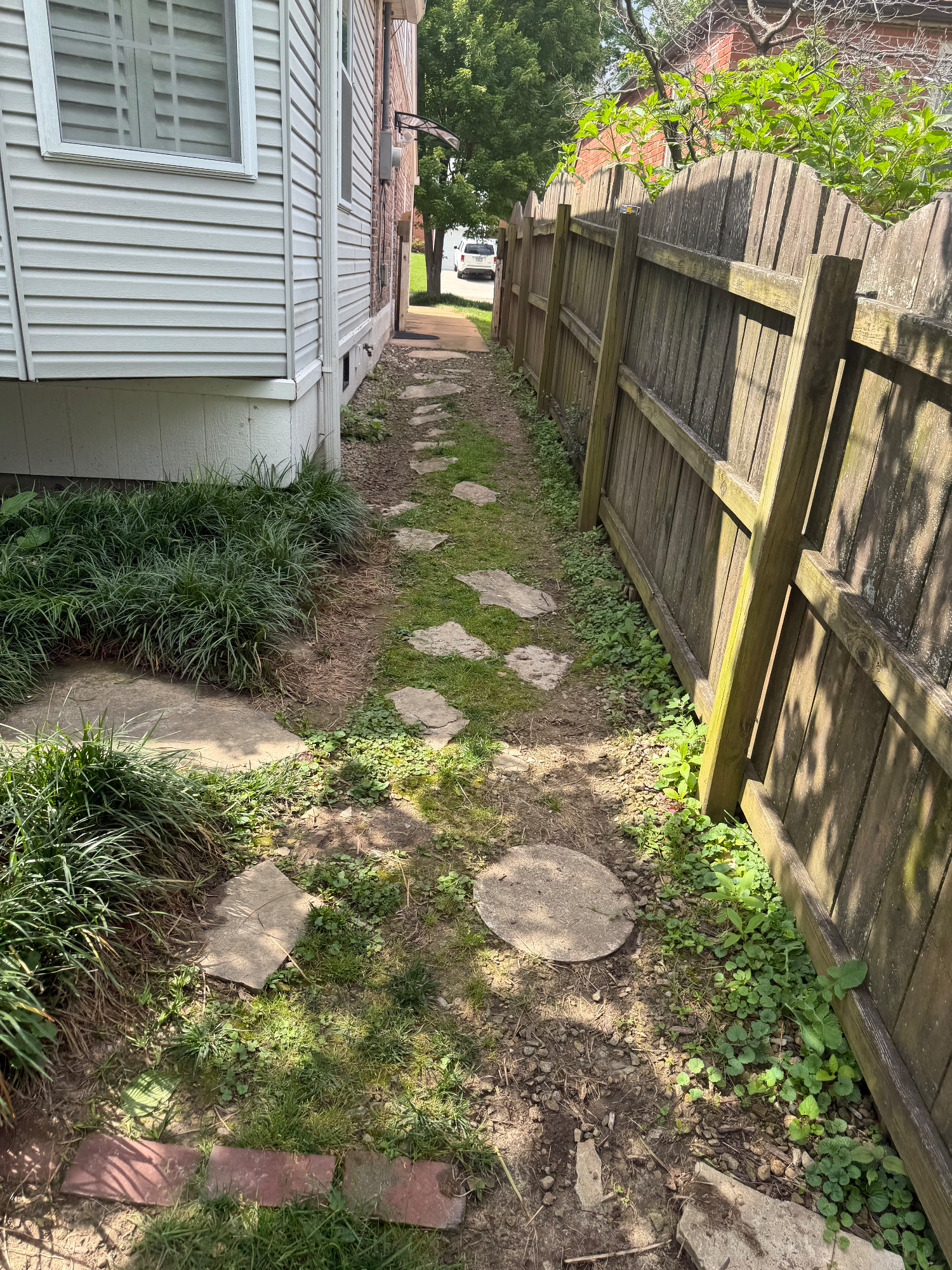 Worn walking path and deteriorating patio before site prep work in Brentwood