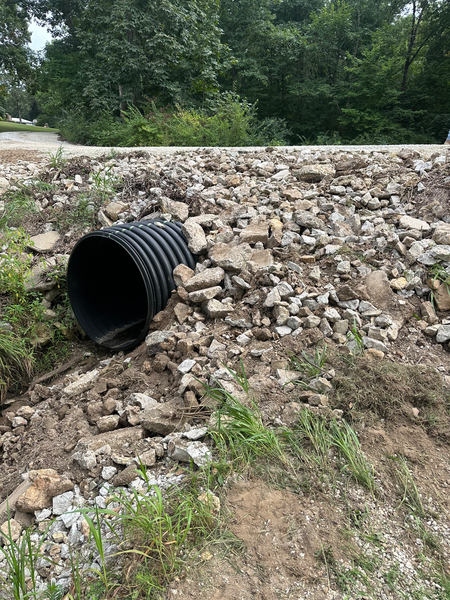 Rebuilt gravel driveway with restored hillside and replaced culvert in Montgomery City