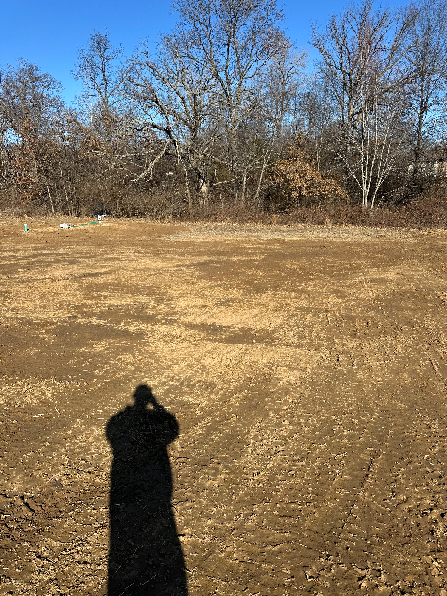 Finished graded yard sloping away from the house foundation after smoothing and drainage work