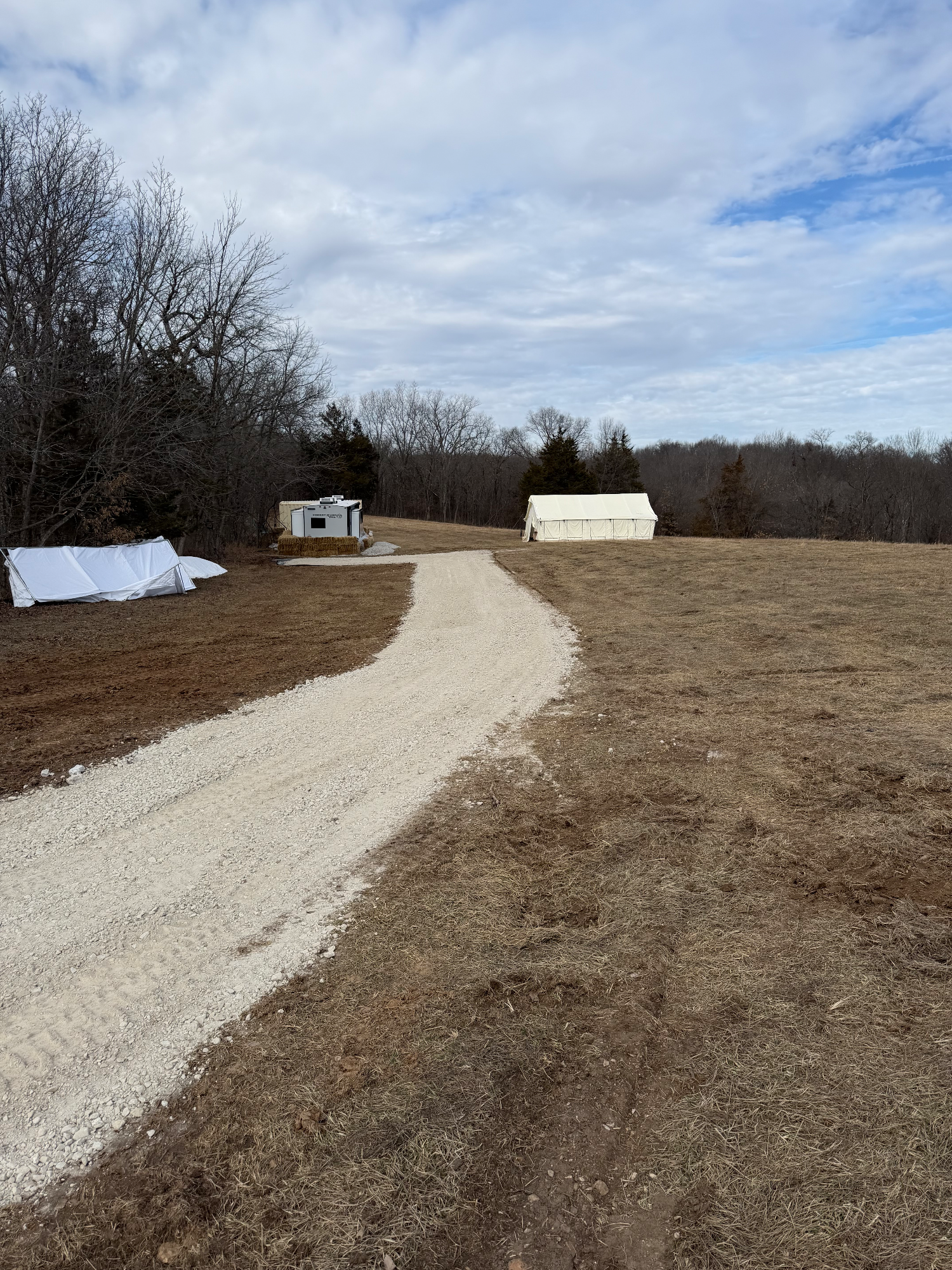 Finished gravel driveway with compacted layered rock base ready for future home construction