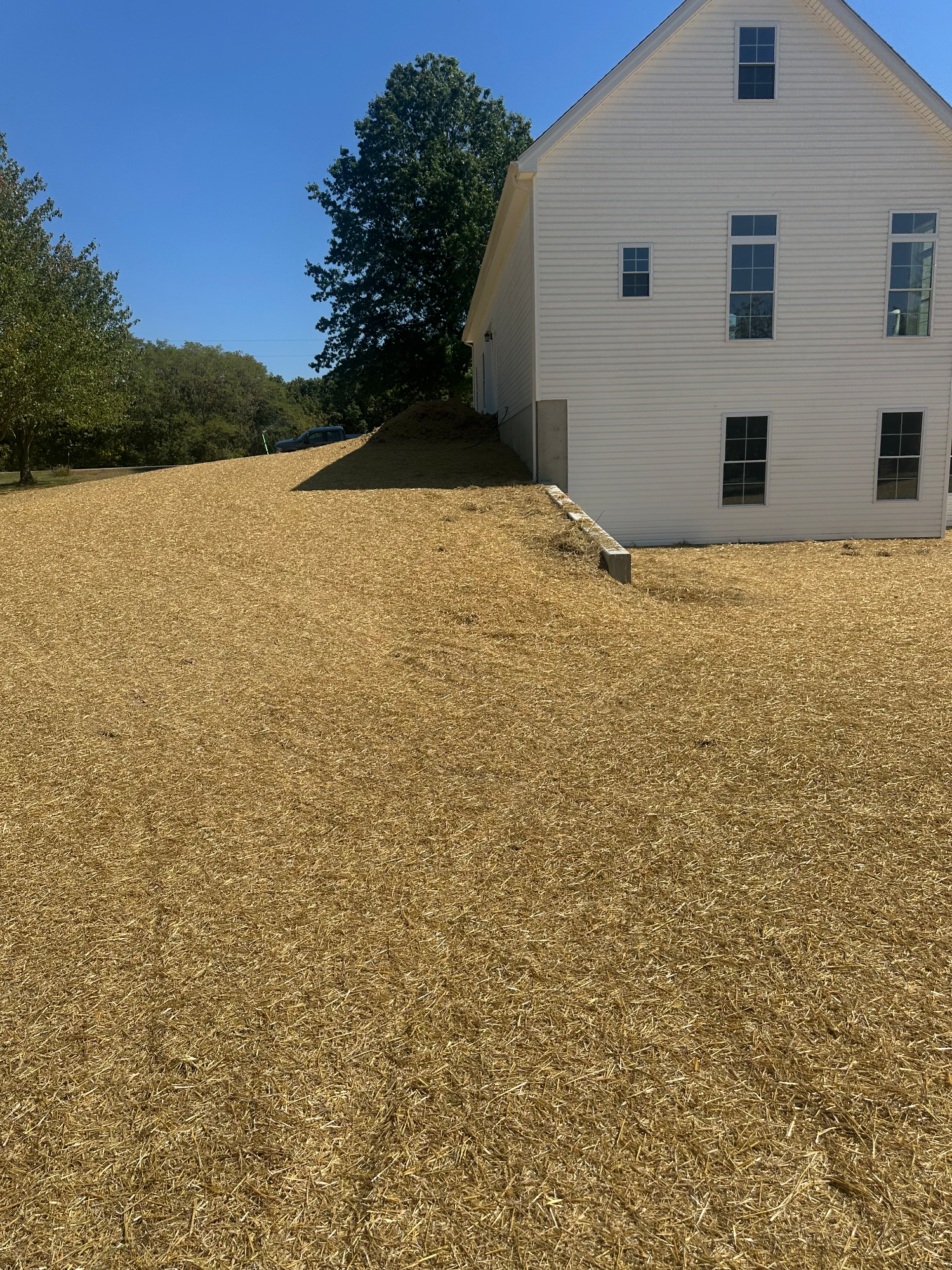 Completed French drain system routing gutter water away from new home foundation